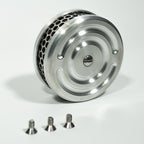 Close-up image of a chrome air cleaner mounted on a motorcycle engine.